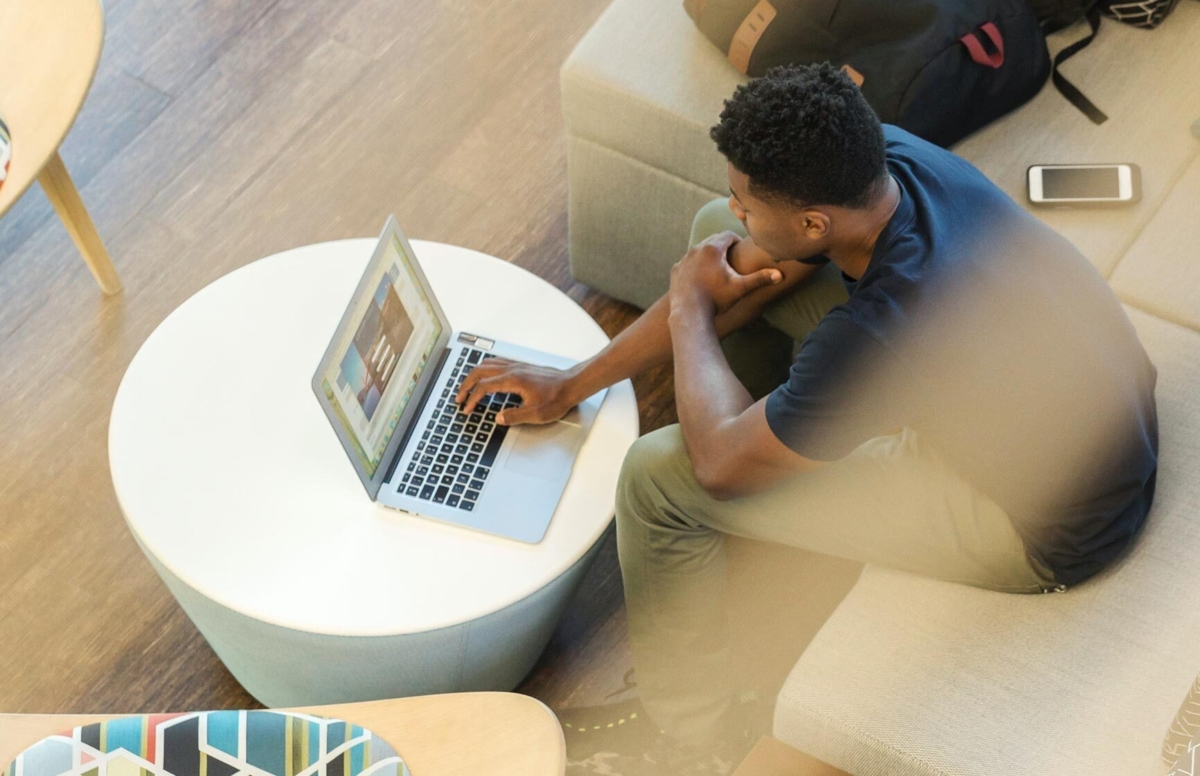 Overhead shot of man working at a laptop.